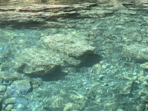 Sea transparent surface with stones at the bottom of sea
