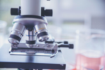 Science microscope equipment in biology chemical laboratory. Scientific experiment Microscope on Lab table microbiology equipment. Chemistry objects on lab background. Chemistry scientific concept