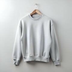 Blank light grey sweatshirt hanging on a wooden hanger against a white background.