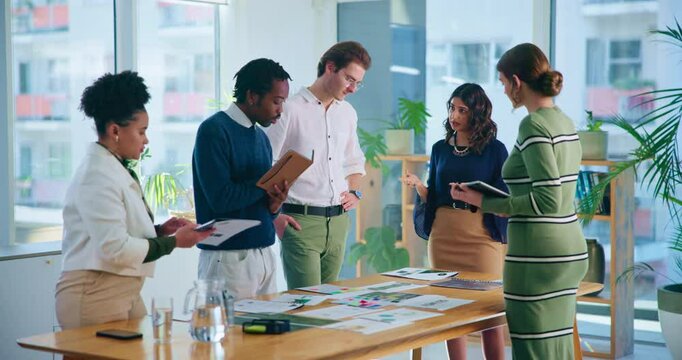 Business people, documents and meeting with creative team for company growth, development or planning at office. Young group, employees or colleagues with paperwork for brainstorming or discussion