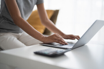 Business woman working from home. work online on laptop. Asian businesswoman working on sofa online business with social distancing laptop online meeting