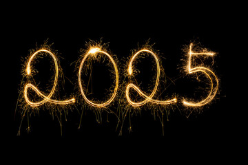 Happy New Year 2025. Burning sparkling text 2025 isolated on black background.