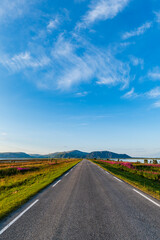 Andoya scenic landscape with long straight road leading into horizon in Norway. national tourist route in Norway. national tourist route on Andoya, Nordland, Norway