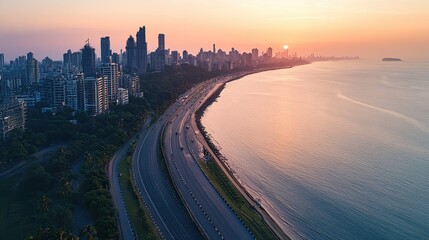Aerial view of Mumbai iconic Marine Drive curving along the Arabian Sea, with the skyline in the background.