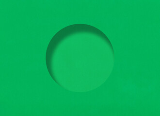 Green paper background with minimalistic round hole and have shadow.