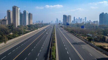 An empty stretch of the Eastern Freeway, with a panoramic view of Mumbai skyline in the distance.