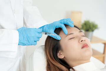Fototapeta premium Cosmetic surgery, skin whitening injection, filler injection, Skin reface, beautiful Asian girls receive beauty treatments at beauty clinic, skincare, pore rejuvenation, wrinkle, baby face
