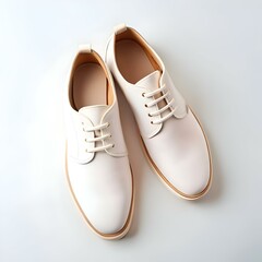 A pair of stylish white leather lace up shoes with a classic design and a minimalist aesthetic.