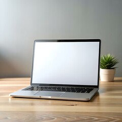 Fototapeta premium A modern laptop with a blank white screen sits open on a wooden desk. ready for your text or design.