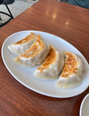 Fresh crispy pan fried handmade gyoza dumplings served at a Japanese restaurant