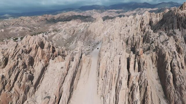 Panoramic aerial image revealing the iconic Ruta 40 winding through the magnificent Quebrada de las Flechas in Salta, Argentina.