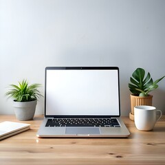 Fototapeta premium A clean. minimalist workspace with a laptop. a potted plant. and a mug on a wooden desk.