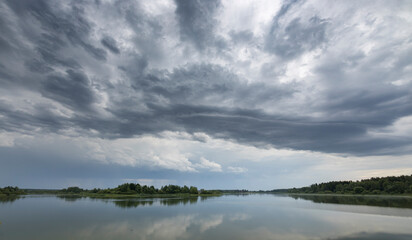 A cloudy sky with a lake in the background