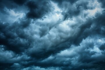 Fototapeta premium Dark clouds with dramatic lighting. Cloudy sky with dark gray and white colors. Stormy weather, a poor time of day. Wide-angle photograph