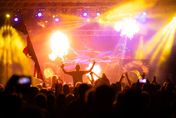 Crowd at concert and colorful stage lights.