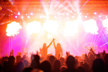 Crowd at concert and colorful stage lights.