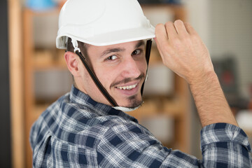 young worker with hardhat in a factory