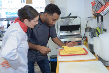 Fototapeta premium chef cutting parma raw ham