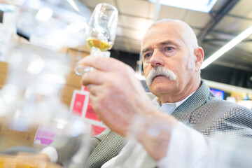 satisfied elderly man holding a glass