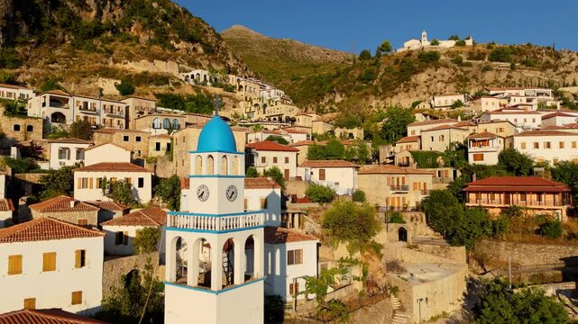 The ancient town of Dhermi, Albania, with a blue-domed clock tower nestled in the mountains