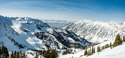 Ski resort vista, looking out on snow covered mountains with mountains as far out as possible