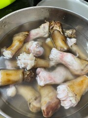 Goat trotters ready for boiling in a pan 