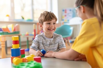 Fototapeta premium Portrait of a child with autism working with a therapist during a session, both smiling and interacting positively. The therapy room is welcoming and filled with educational tools.