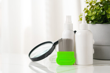 Green Comb on a Countertop with Lice Treatment Products