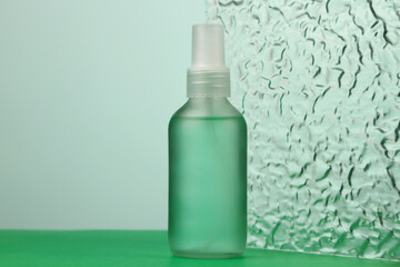 Cosmetics for face skin care. Face serum on green background