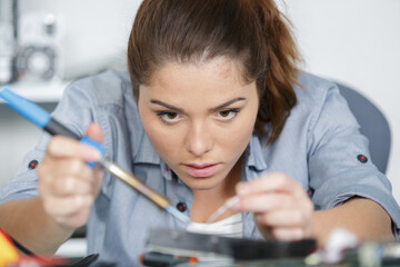 woman is soldering a pc part
