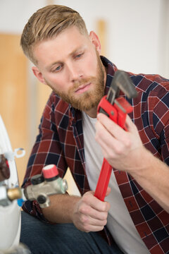 plumber man with tools in the kitchen