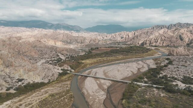 Receding aerial movement from the Rio Calchaqui bridge at the Quebrada de Las Flechas, Salta, Argentina, South America.