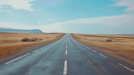 Fototapeta premium Open Road Journey Under Blue Skies Ideal for Travel, Adventure, and Freedom Themes