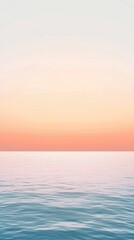 Obraz premium Serene ocean view at sunset with soft pastel hues reflecting on calm water, perfect for tranquility and relaxation themes.
