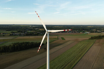 Wind turbine on green fields close-up