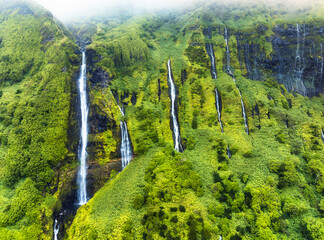 Green waterfall tropical landscape - Ribeira do Ferreira, green paradise hidden in Flores Island,...
