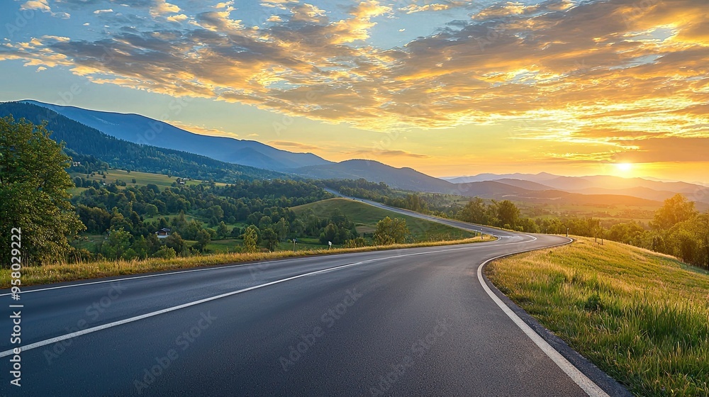 Wall mural beautifully curved asphalt road stretching through a scenic landscape at sunset. the road is bordere