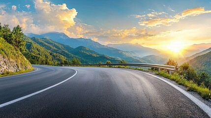 beautifully curved asphalt road stretching through a scenic landscape at sunset. The road is bordered by lush green trees and mountains