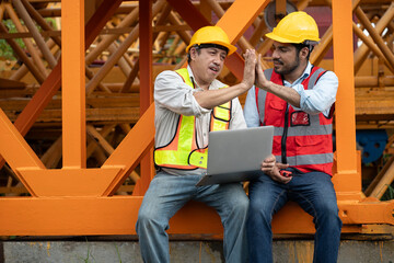 Asia engineer man worker use tablet computer and hand touching with India engineer man with crane spare part background	