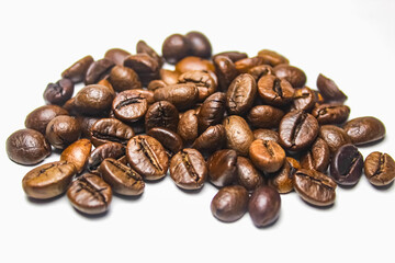 pile of roasted coffee beans isolated on white background