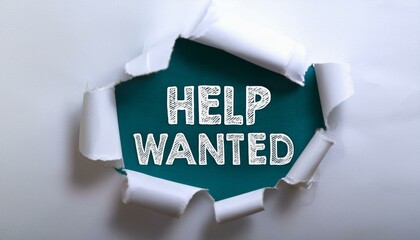 The text HELP WANTED appearing behind torn white paper
