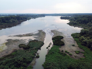 River winding through dense green woods