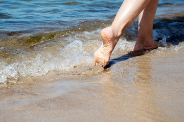 Woman walks along the seashore with blurred areas