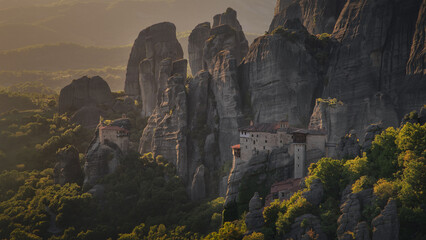 Meteora Monasteries nestled among dramatic rock formations at sunset