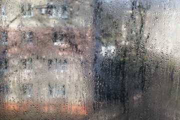 view from the window with drops on the glass