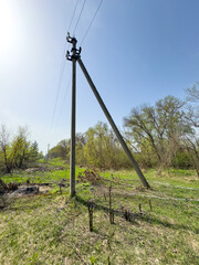 A pole with electric wires against a blue sky