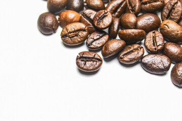 close-up of roasted coffee beans with negative space isolated on white background