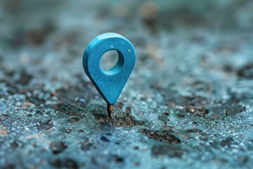 Blue location pin standing on a rough stone surface, symbolizing adventure and exploration