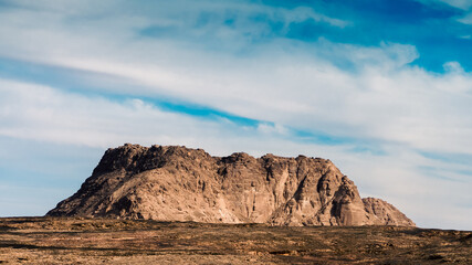 Obraz premium high mountain in the desert against the blue sky and white clouds in Egypt Dahab South Sinai