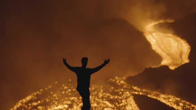 Pacaya Volcano, Guatemala - A Silhouette of a Man Posing Near the Glowing Rivers of Molten Lava at Night - Handheld Shot